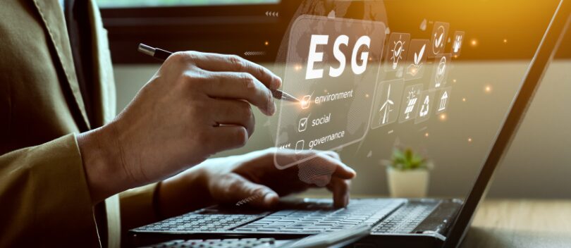 Director with the word 'ESG' over computer